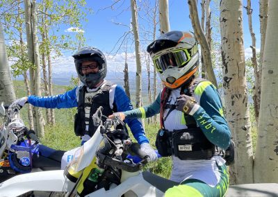 Picture of off road guides with Enduro Ranch in bright outfits amongst bright aspen trees.