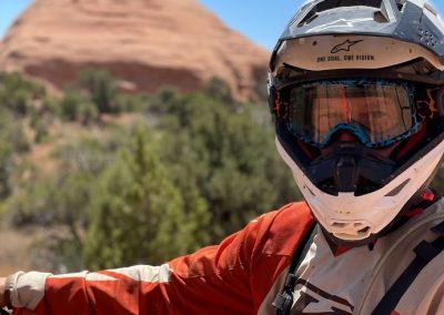 Picture of Brett Johnson dirtbike guide with red sandstone rock pyramids in the background