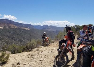 Image of hard enduro trail with rider coming onto a mesa.